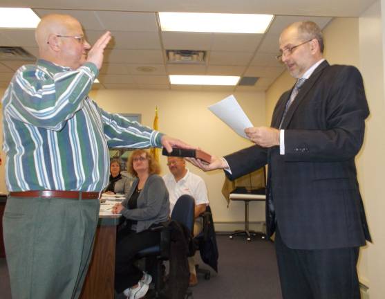 Photo by Vera Olinski Sussex Borough Administrator Mark Zschack swears in new councilman Mario Poggi at Tuesday night's council meeting.