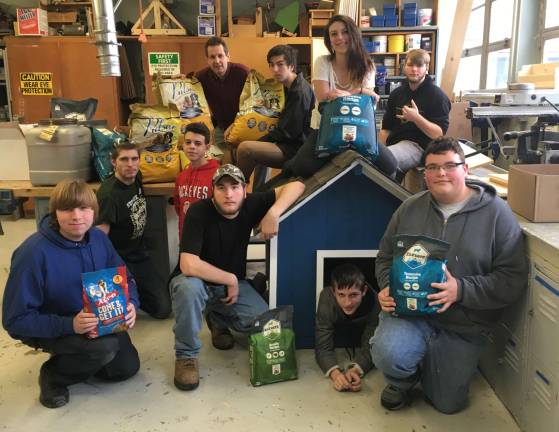 Sussex Tech class 'stuffs the doghouse' Mr. Wagner and his students display the completed dog house.