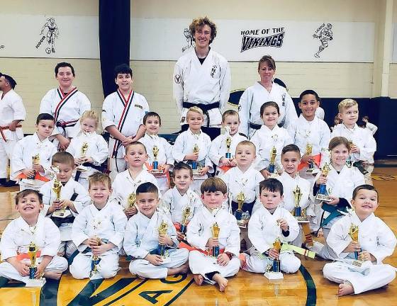 Ranger level students show off the trophies they won for their Kata performances.