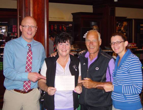 Crystal Springs GM Adam Donlin, Buffy Whiting, John Whiting &amp; Event Coordinator Katie Levin register Buffy&#xfe;&#xc4;&#xf4;s hole-in-one.