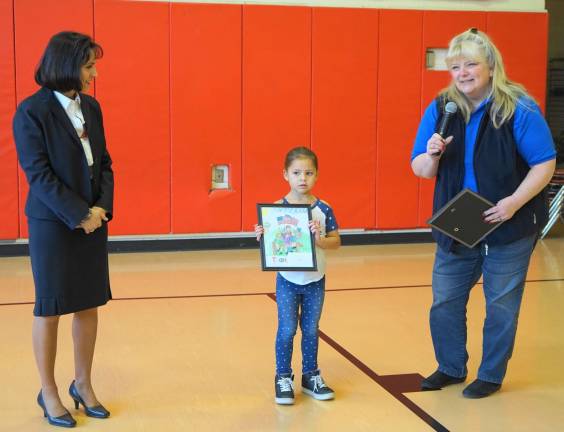 From left, Principal Rosemary Gebhardt, Ruby Jackson, and Cindi Auberger stand as Ruby receives her award.