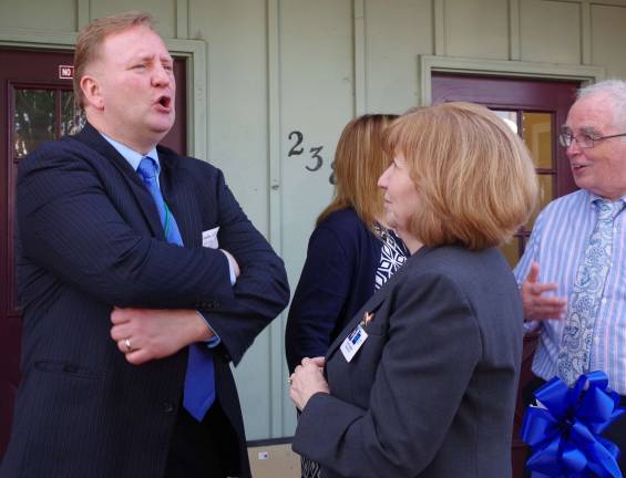 Veteran Navy physician Dr. Andrew Westrom speaks outside with Zufall President and CEO Eva Turbiner. Westrom came to the opening from Maryland representing the U.S. Department of Health and Human Services&#xfe;&#xc4;&#xf4; Health Resources &amp; Services Administration, which among other things helps to provide health resources for medically underserved populations.