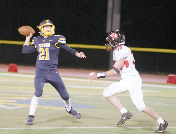 Vernon quarterback Zack Waschek is in throw motion late in the game. Waschek threw for 357 yards resulting in 2 touchdowns