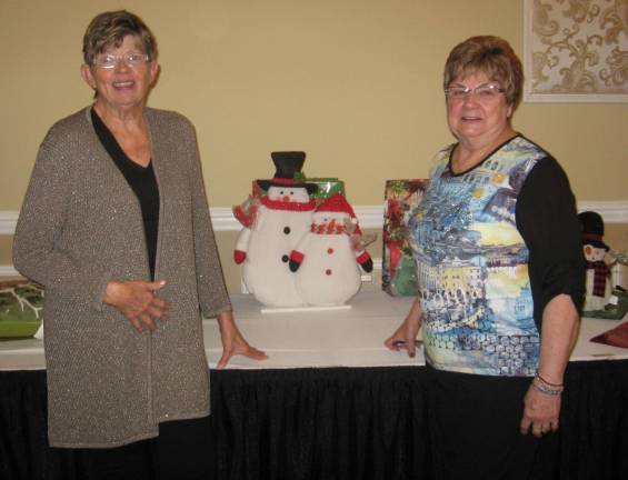 Leisure Club celebrating the season PHOTOS BY JANET REDYKEPresident Lorraine Kraus (left) and member Tina Kempka pose at the prize table.