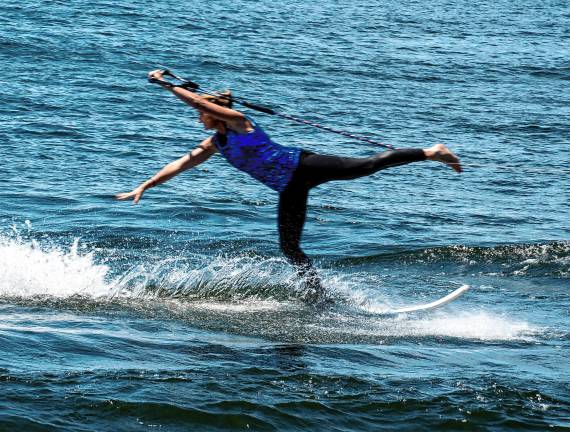 Sparta. Fourth of July events Meghan Lieb does an overhead press on a swivel ski in the Lake Mohawk Ski Hawks show.