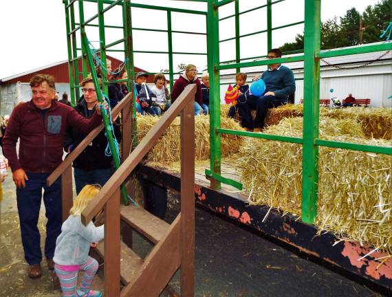 Sussex Christian school holds harvest festival Tractor driver and volunteer Carl Olinger greets kids boarding the hayride last Saturday at the Sussex Christian School's Harvest Festival Oct. 1st at the Fairgrounds.