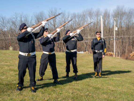 The honor guard fires during the ceremony.