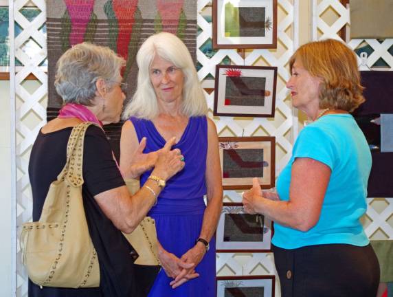 At center, Carol Chave talks about her art.