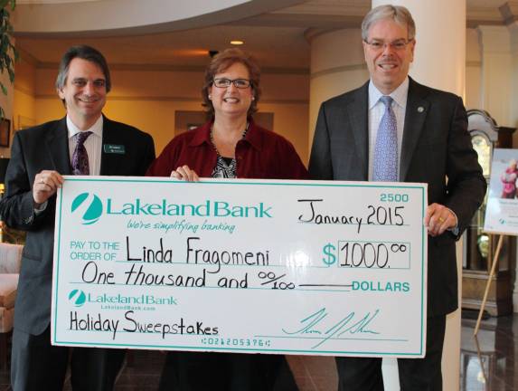 Linda Fragomeni, center, accepts her $1,000 check as the Lakeland Bank Holiday Debit Card Sweepstakes winner. Tom Shara,president and CEO, right, and Al Losco, area branch manager of Branchville and Lafayette, were happy to present Fragomeni with the grand prize check.