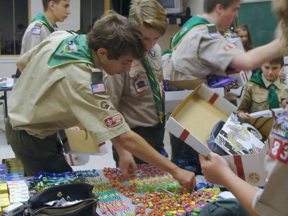 The boys carefully arrange the items in Boxes of Joy.