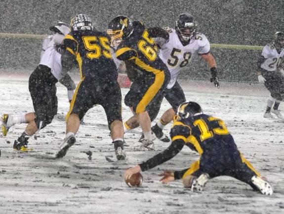 Vernon quarterback Tyler Soltes reaches for the ball he fumbled moments before in the second quarter. Soltes was able to recover the ball.