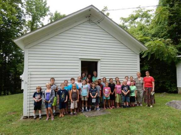 The children in the Hands-On History program spent a morning at the historic one-room schoolhouse at Prices Switch Road, learning what school was like at the turn of the 19th century.