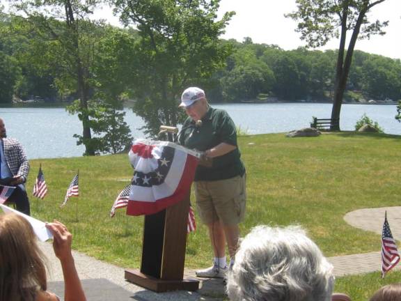 James Opfer begins the Memorial Day ceremony Monday, May 29. Behind him is Highland Lakes’ main lake.