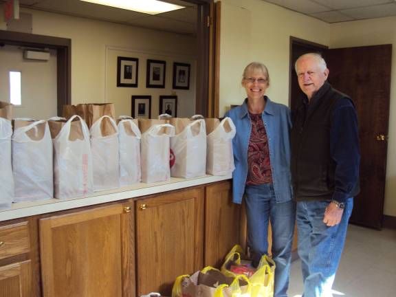 Holy Counselor Lutheran Church of Vernon helped 10 families for Easter with Easter food baskets. Pictured is group coordinator, Leslie Deutch and Bill Bonstra, congregational advocate to Thrivent Financial. Along with financial support from Thrivent Financial, members of Holy Counselor donated the food for the baskets.