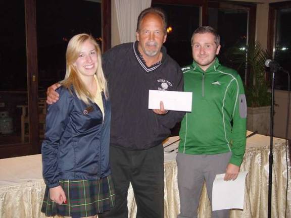 Don Hemberger receives his Low Net Champ prize from Mark Melillo and Caitlin Zaleski