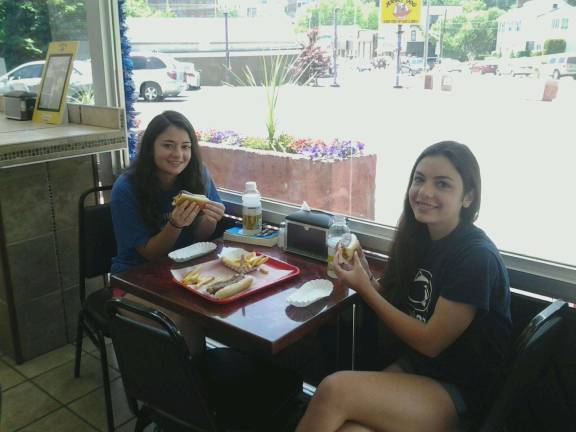 Photos by Don Carswell Sisters Holly and Lauren Beck enjoy their lunch at Jersey Dog in Newton.