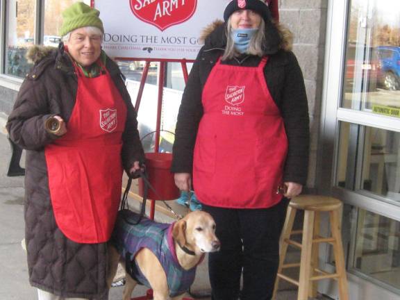 PHOTO BY JANET REDYKE Volunteers Judy Storms and Mary Ellen Vichiconti are outside the Vernon Acme collecting much needed Christmas donations for the Salvation Army. Also in the photo is Storms' therapy dog Jack.