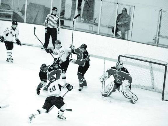 Wallkill Valley/High Point tops Jefferson in hockey From left Jefferson's Tommy Walsh (10) is about to hit the puck with High Point-Wallkill Valley's goalie Dan Kardan in front of the goal post. Kardan intercepted the puck.