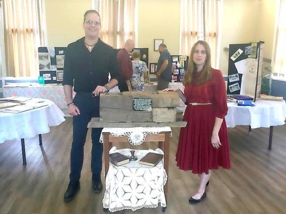 Clyde Bracknell and Pastor Megan Mead-Bracknell with the 150 year old beam from the church.