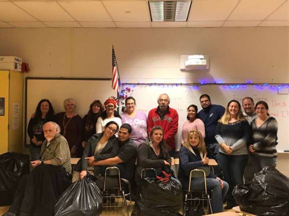 Photo provided Project Help volunteers &#x2014; the first four women in the back row from the left, Karen Riernsten, Sandy Mitchell, Michelle Gray and Elizabeth Wizniewski &#x2014; pose with veterans and their families at the Santa Shop