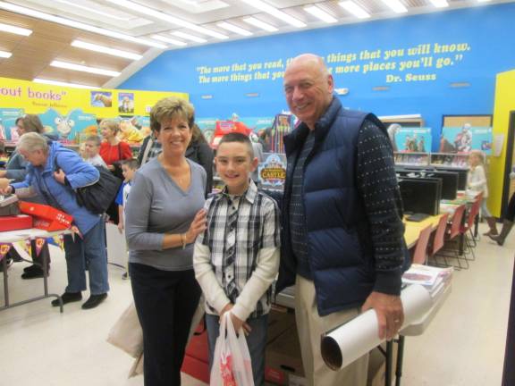 Tyler Douglas is shown with his frandparents, Michael and Joan Kirchmer,&#xa0;at the book fair.