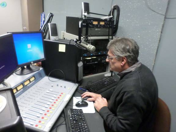 Anthony Selimo, founder of the Sussex County Community College radio program, sits at the control board of the college's 1620 AM station and future 97.5 Fm station. Photo by Nathan Mayberg