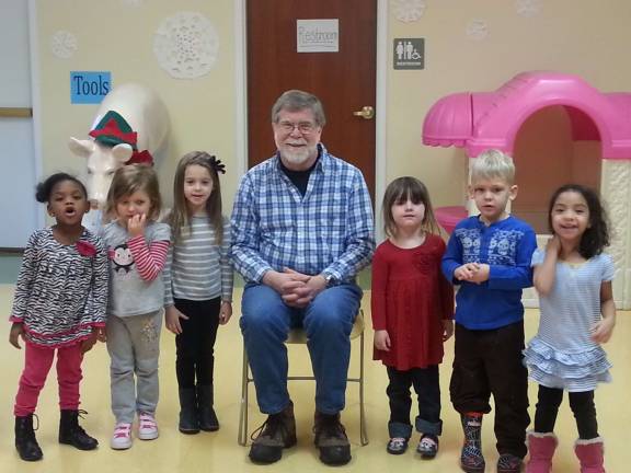 Don Hall is pictured with the students at Little Sprouts Early Learning Center.