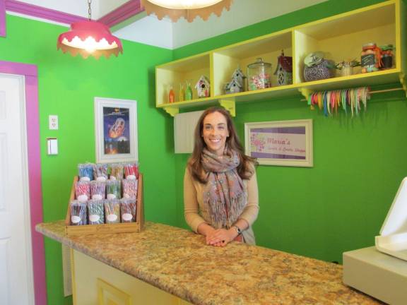 Photos by Laurie Gordon Maria-Victoria Gicala at the counter of her new candy store on Spring Street.