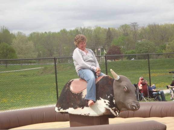 Maria Grizzetti, of Stanhope, tries her luck on the mechanical bull.