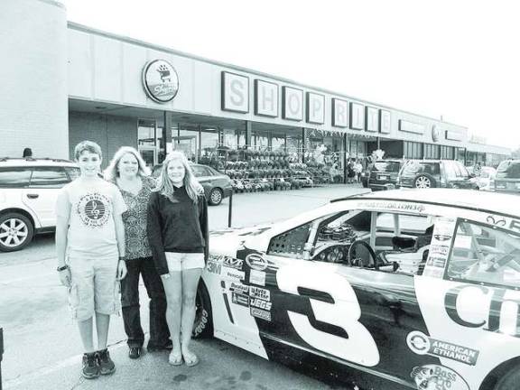 Supermarket, church team up for charity Jeffrey Schnebelen, Live Hopkin, and Julia Kotkin from Vernon United Methodist Church pose next to the Cheerios race car to raise awareness and funds for the Church’s food pantry.