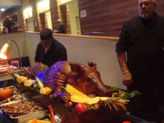 A well-dressed pig is served courtesy of Ed Zydel and Al VanHaarlen of Pine Hill Farm, in Wantage.