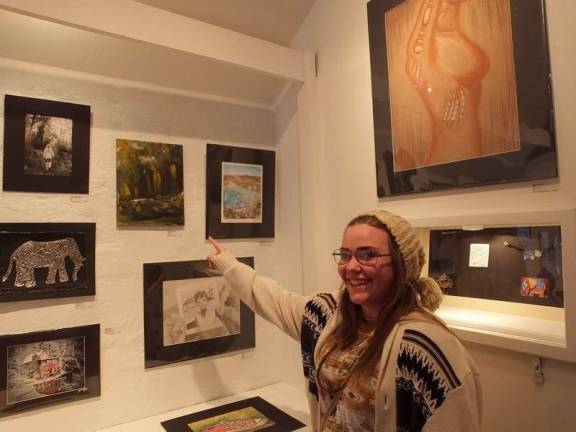 Getting creative Wallkill Valley Regional High School artist Sarah Hadowanetz points to her abstract creation called "Turmoil."