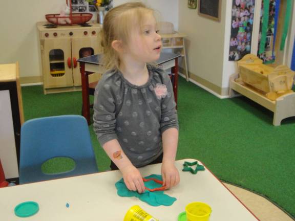 Aubree Baldassano, 4, uses a mold to make Play-Doh fish.