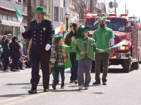 Newton goes green Marchers from the Hamburg Fire Department wave to the crowd.