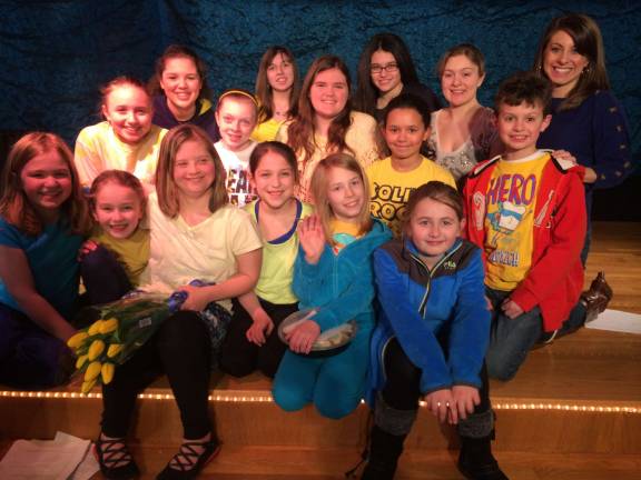 Photo provided Rachel Bailey with her class on stage at Acting-a-Part during last week's surprise celebration. Bailey's teacher and peers presented her with flowers and celebrated World Down Syndrome Day.