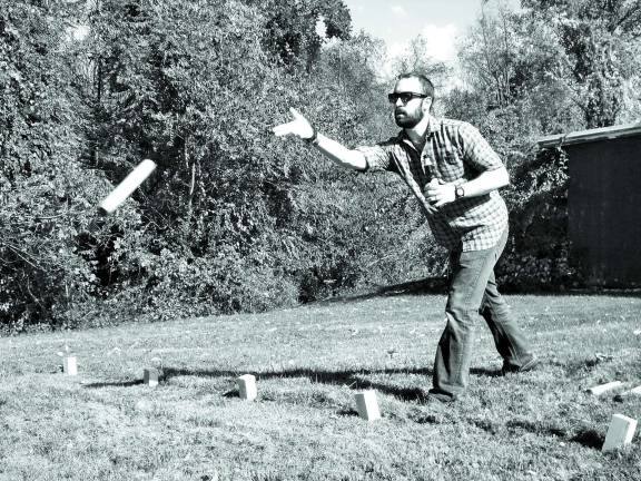 Honoring the Vikings Photos by Scott Baker Lafayette resident Barry Vaughan attempts to knock down an opponent's pawns in a game of kubb, a kind of Viking lawn chess.