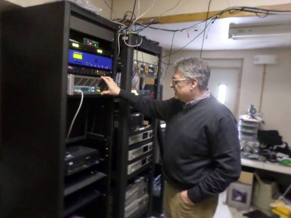 Anthony Selimo examines the transmitter of the Sussex County Community College radio station. The 1620 AM signal is operational within a mile of campus while the FM signal will have a much greater reach when it goes online this fall. Photo by Nathan Mayberg