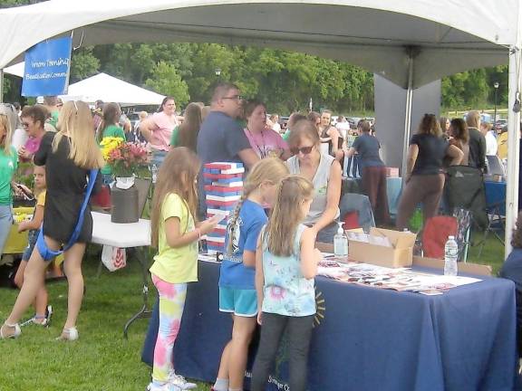 Booths and tables were crowded and active (Photo by Janet Redyke)