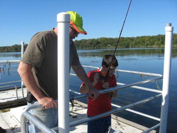 Nature kids go fishing at the refuge The sweet smell of fishy success for the first catch of the day.