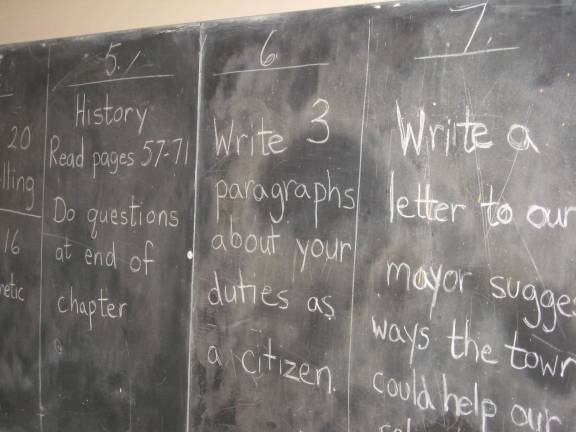 Class in session at Price's Switch School Classwork designated for each grade was recorded on the chalkboard.