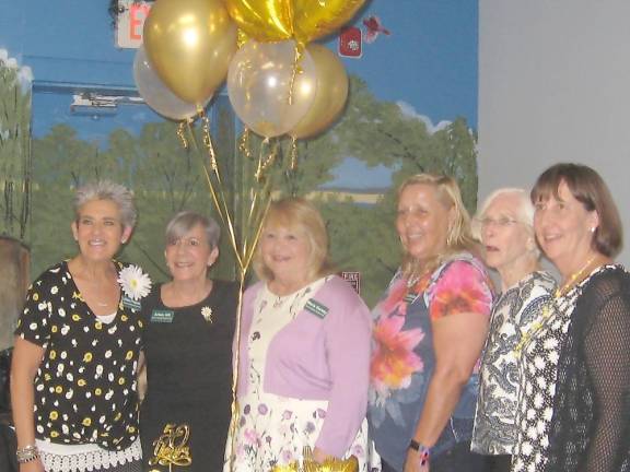 Woman’s Club President Maria Dorsey (center) and members capture the moment.