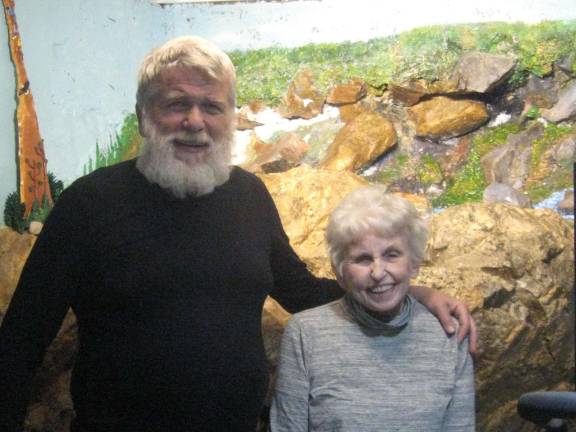 PHOTOS BY JANET REDYKE Nels Nilsen and Ruth Preston pose in front of their seven- foot basement rock mural.