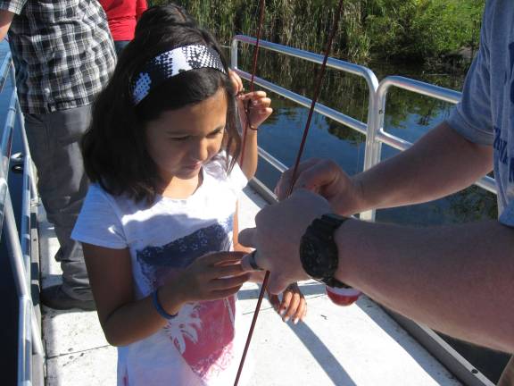 A squirmy worm, no problem for this fisher girl.