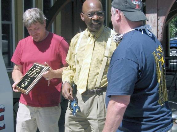 Vernon Mayor Howard Burrell presented Tracks Deli owners Scott Jahnke and Kevin Mitchell with a plaque. (Photo by Janet Redyke)