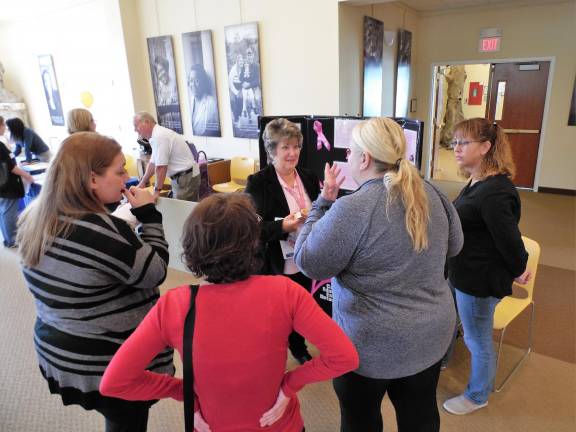 Marty Baldwin, of NJ CEED, discusses health care screenings with an attendee at a recent Health Fair at Project Self-Sufficiency.