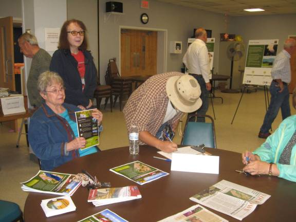 PHOTOS BY JANET REDYKEInterested individuals sign in at the Western Highlands Scenic Byway meeting held on Oct. 15.