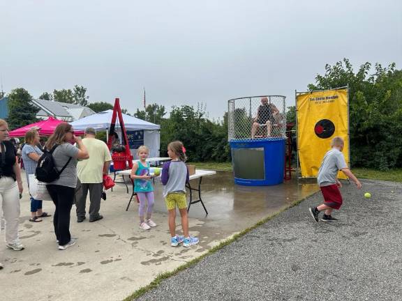 VF1 A boy tries to dunk Mark Scilingo of the Vernon Township Fire Department in the dunk tank at the Vernon Street Fair on Saturday, Sept. 9. (Photos by Daniele Sciuto)