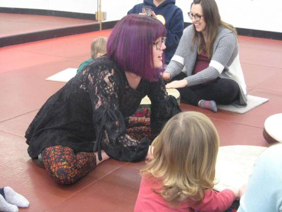 Bumblesong offers music classes to area families Miss Nicole leads the drummers.