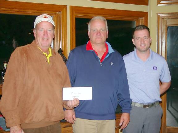 Peter McIntyre and Bob Setz receive their Low Gross winner’s prize from General Manager Ryan Delaney.