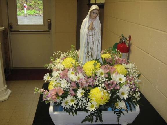 The Our Lady of Fatima statue represents the vision that three Portuguese children experienced 100 years ago.